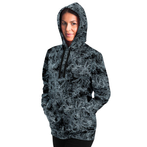 unisex black and white hoodie left side on female with hands in kangaroo pocket